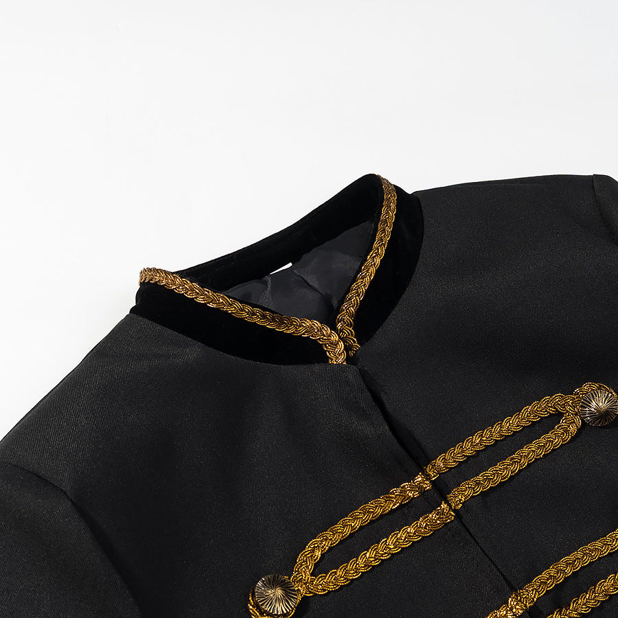 Close-up of the black jacket's gold braided stand collar and decorative front fastenings.