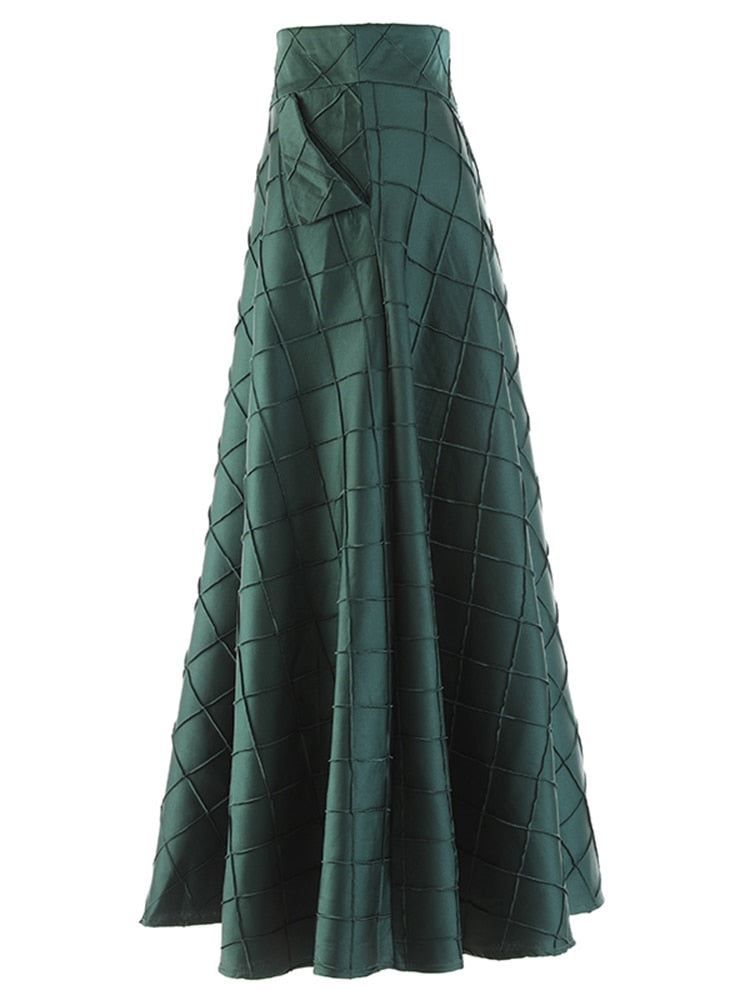 Side view of a dark green A-line skirt showing a slanted pocket and raised grid pattern.