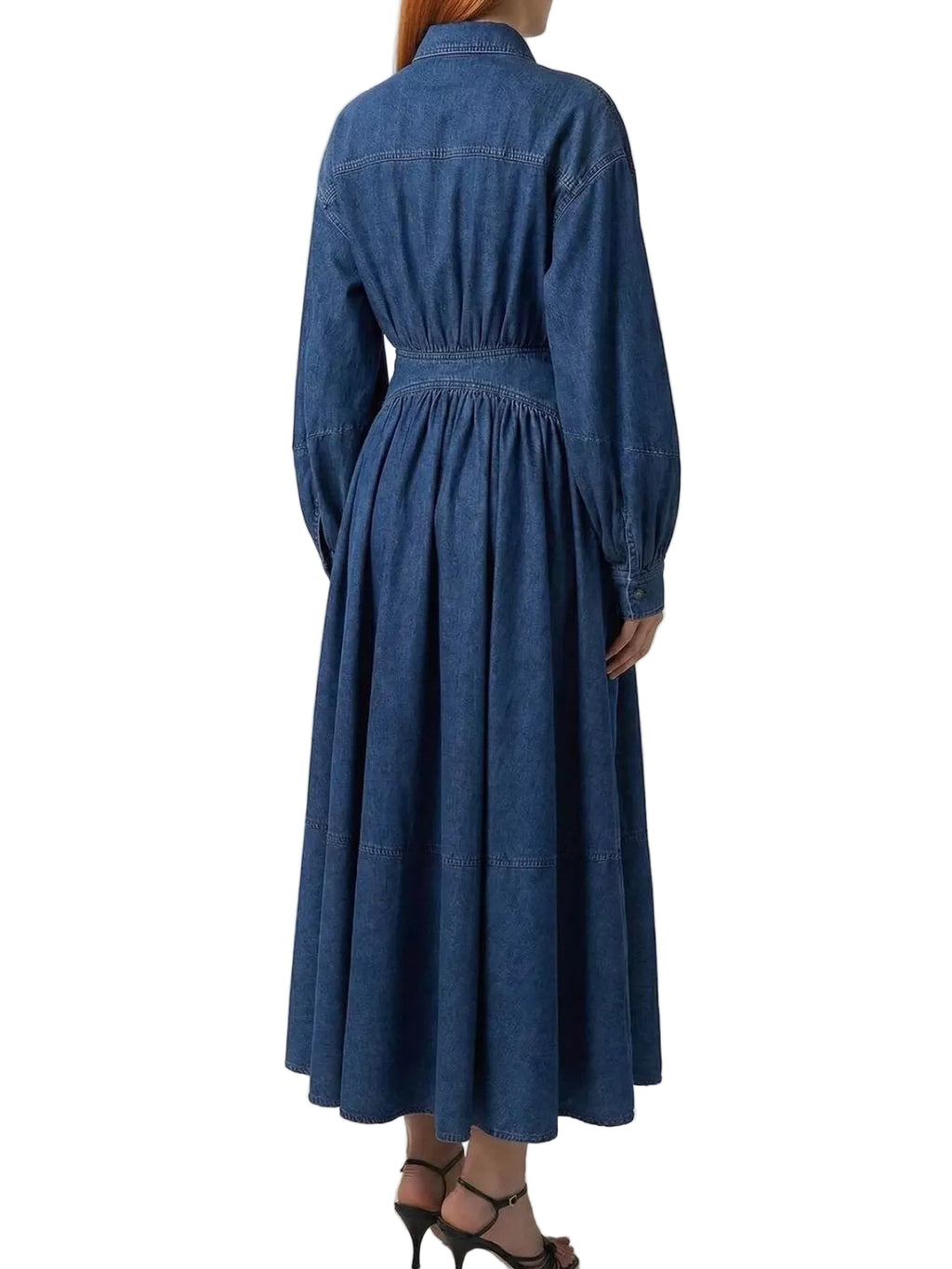 Back view of a blue denim shirt dress with a gathered waist, long sleeves, and flared midi skirt.