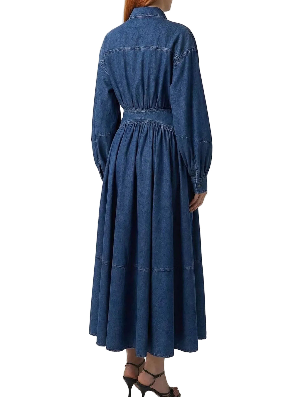 Back view of a blue denim shirt dress with a gathered waist, long sleeves, and flared midi skirt.