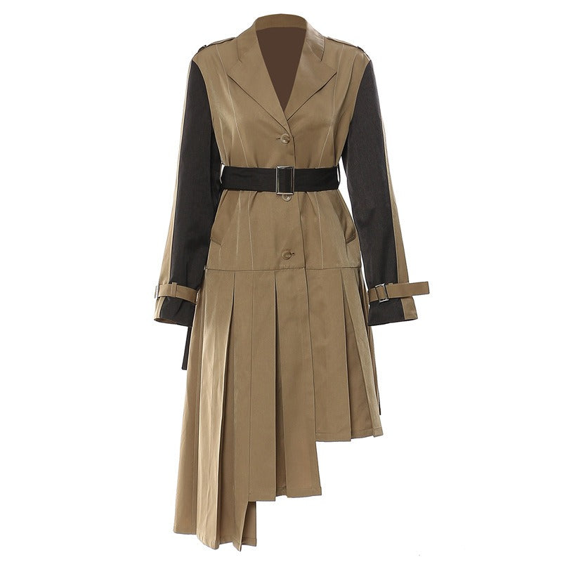 Tan collared dress with black sleeve panels, a black waist belt, and asymmetric pleated skirt, front view.