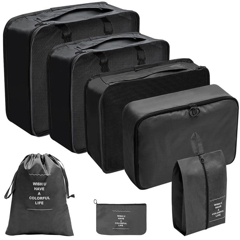 Black travel organizer set with three mesh-top packing cubes, zippered cases, a drawstring bag, and a flat pouch.