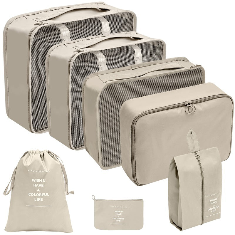 Beige travel organizer set with three mesh-top packing cubes, zippered cases, a drawstring bag, and a flat pouch.