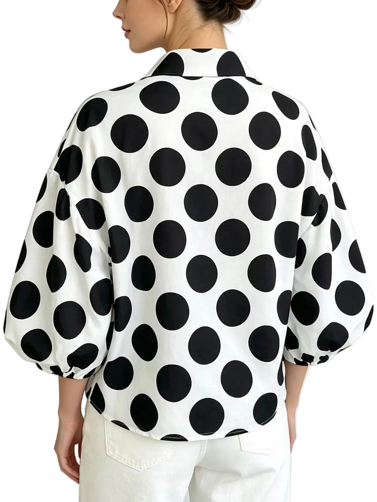 Back view of a white collared shirt with large black polka dots and puff sleeves.