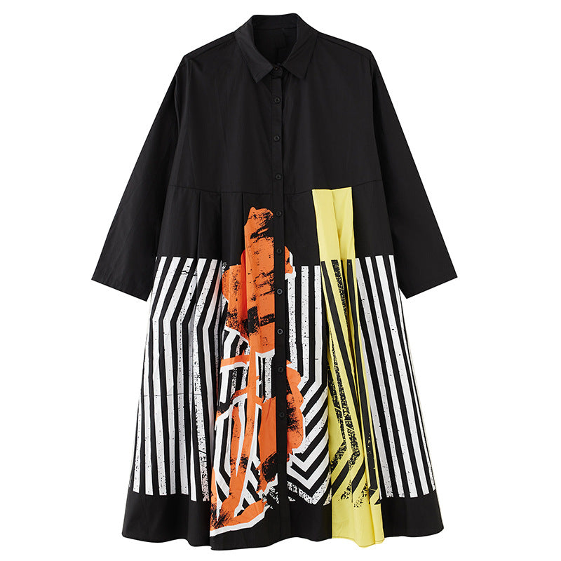 Black button-front shirt dress with orange and yellow abstract panels and black and white stripes, product view.