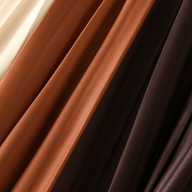 Close-up of rust and dark brown pleated skirt fabric.