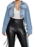 Model wearing a cropped light blue button-front denim jacket with chest pockets and long ties, front view.