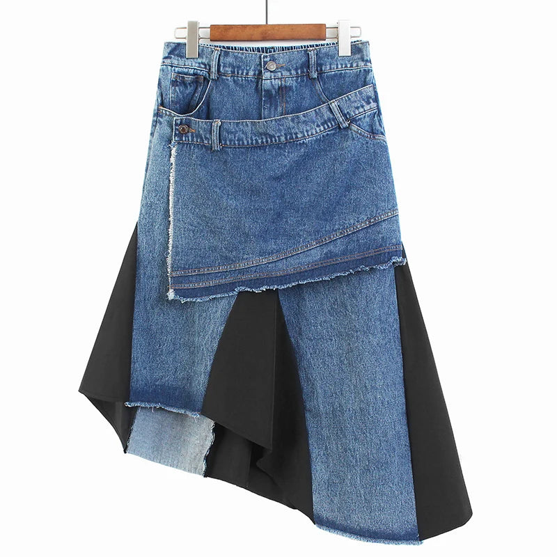 Blue patchwork denim skirt with a diagonal overlay and black inset panels, hanging front view.