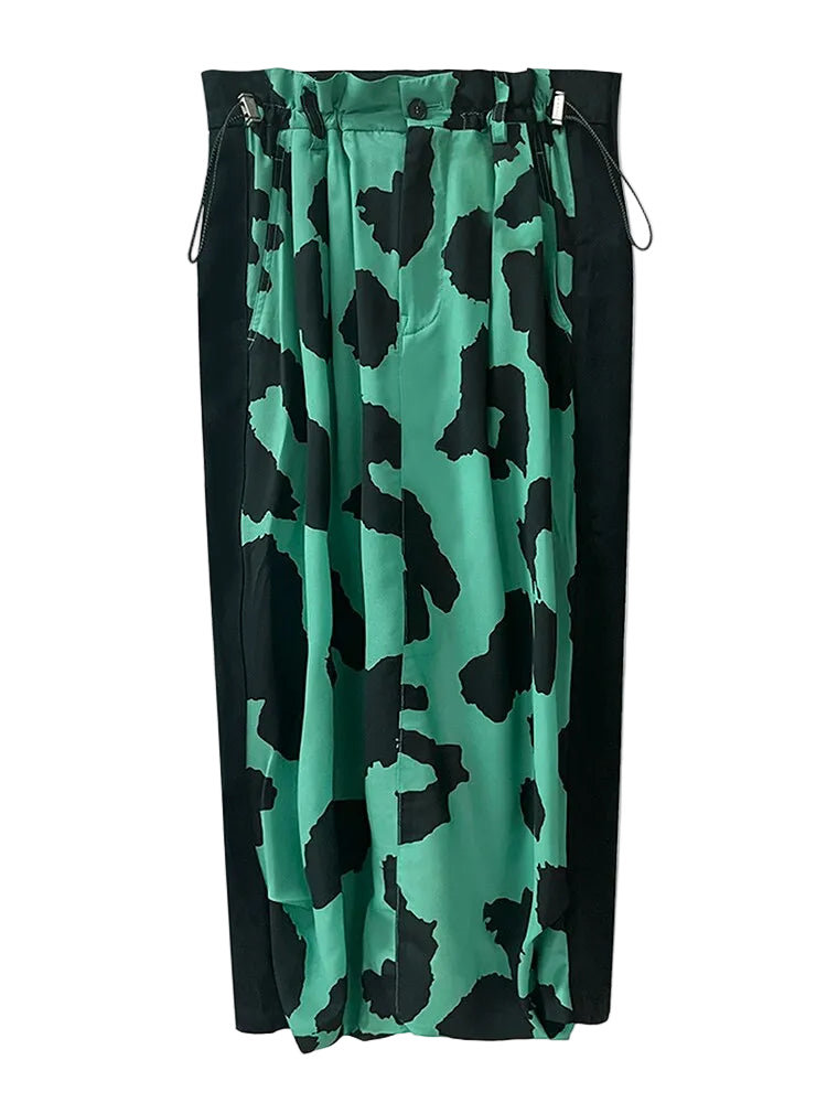 Jade green and black animal-print skirt with black side panels and adjustable waist cords, front view.