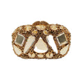 Gold-tone oval clutch covered in large clear faceted stones and smaller gold-tone stones, front view.