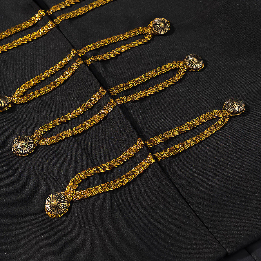 Close-up of gold braided loops and round decorative buttons on black jacket fabric.