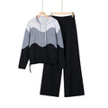 White, gray, and black wave-pattern hoodie with black wide-leg pants, displayed on hangers.