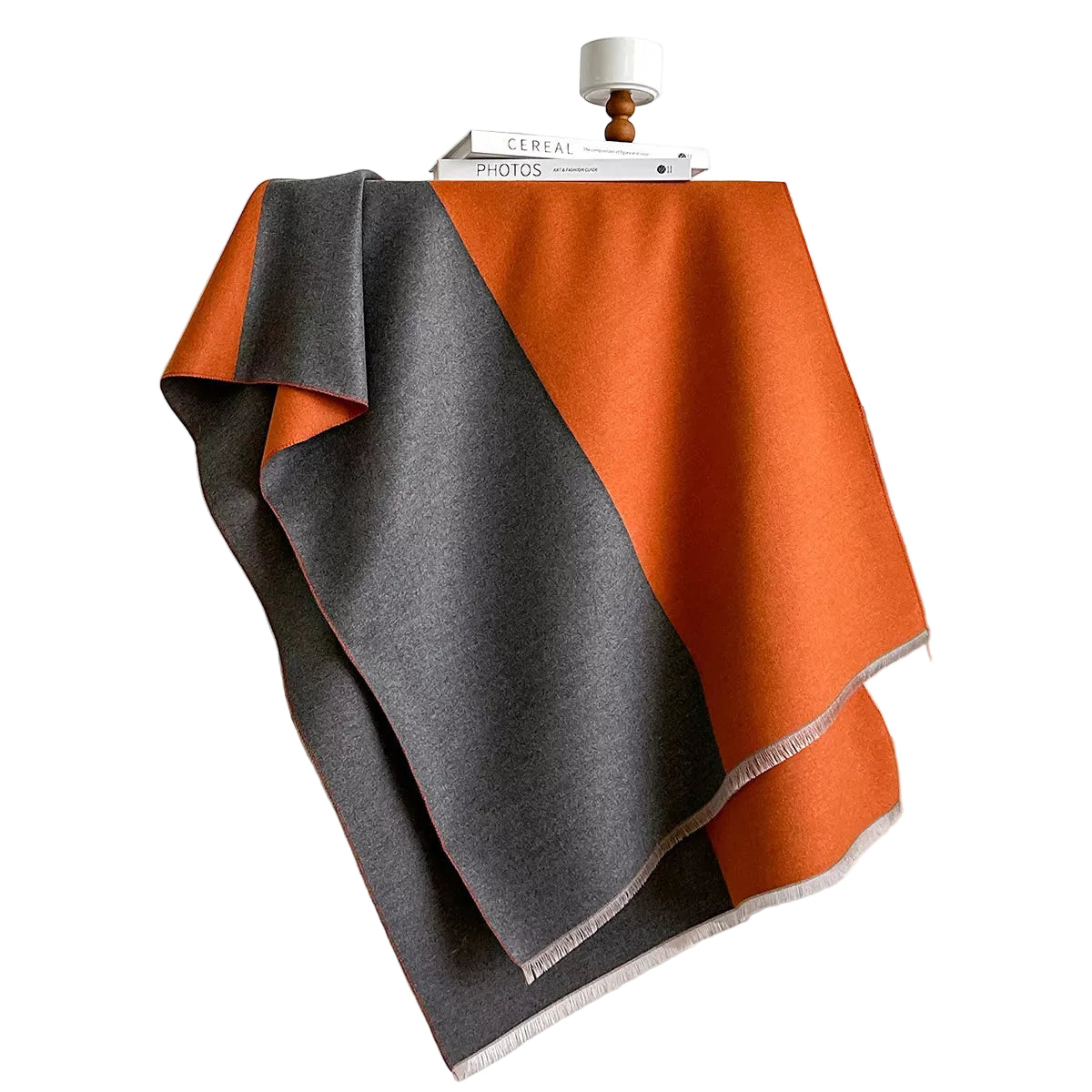 Orange and gray two-tone scarf spread over a chair, showing both color panels and short fringe.