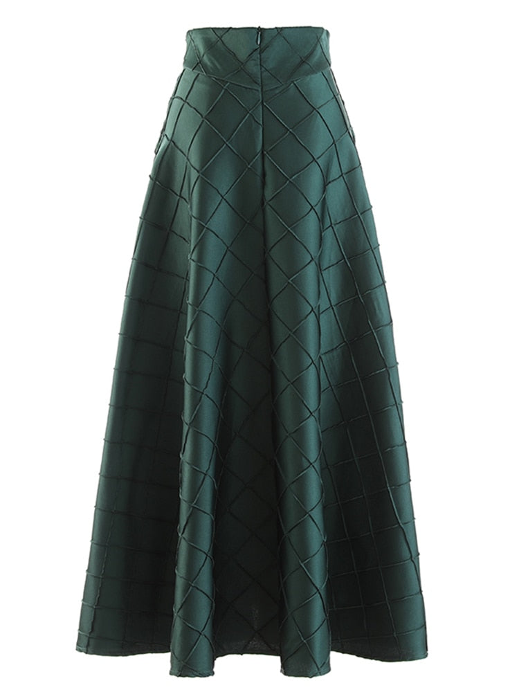 Back view of a dark green A-line skirt with a zipper and raised diamond pattern.