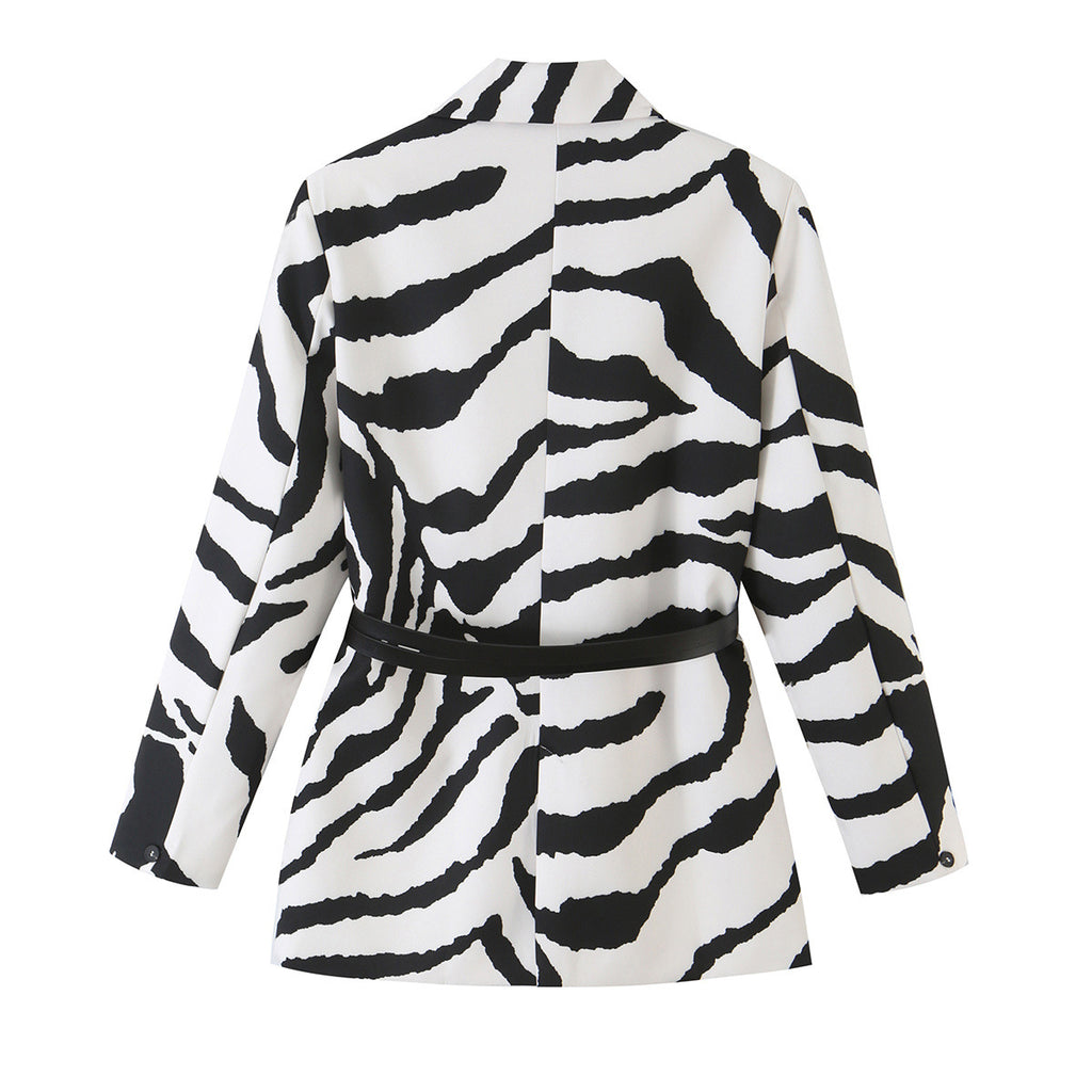 Back view of a black and white zebra-print blazer with a black waist strap and cuff buttons.