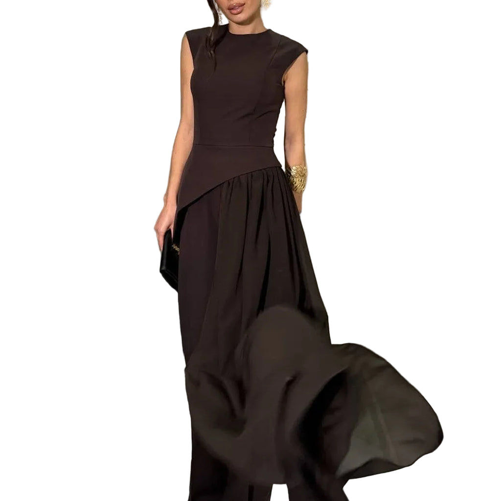 Model wearing a black sleeveless asymmetric top and wide-leg pants, with the sheer overlay lifted outward.