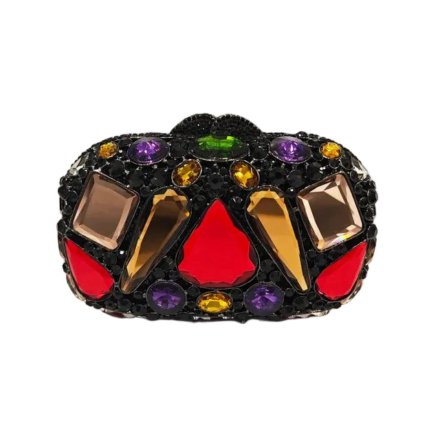 Black oval clutch covered in large red, gold, purple, and green faceted stones, front view.