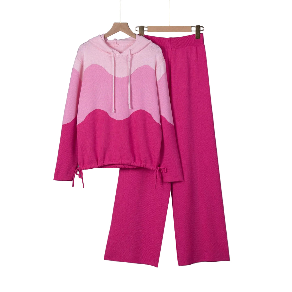Pink wave-pattern hoodie with bright pink wide-leg pants, displayed on hangers.