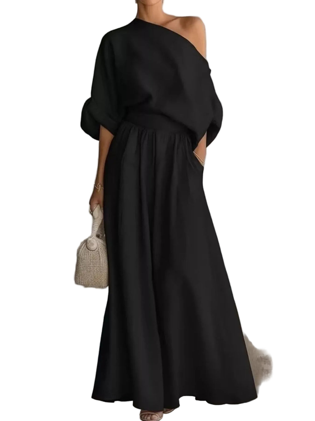 Model wearing a black one-shoulder draped top and matching gathered-waist wide-leg pants, front view.