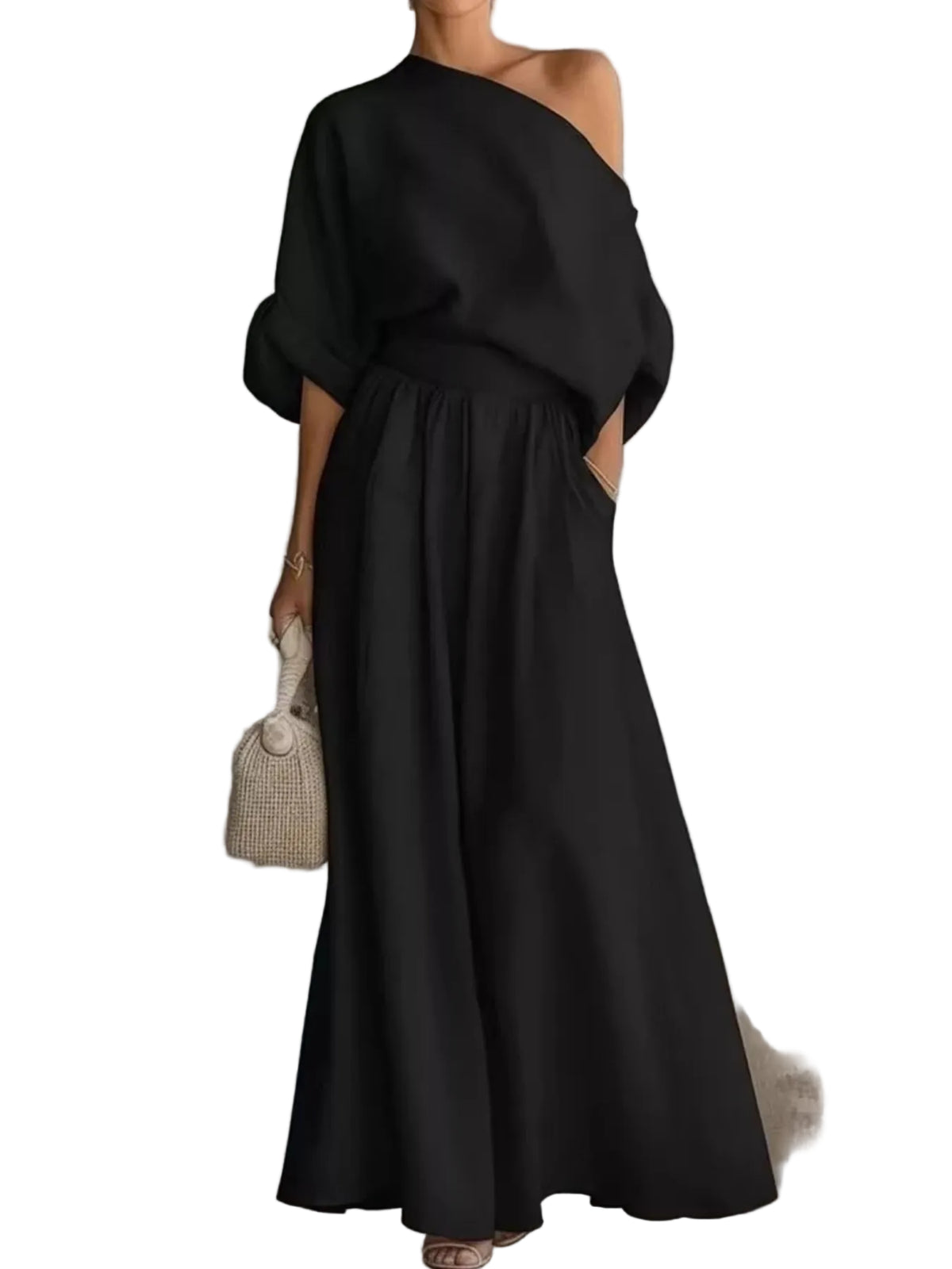 Model wearing a black one-shoulder draped top and matching gathered-waist wide-leg pants, front view.