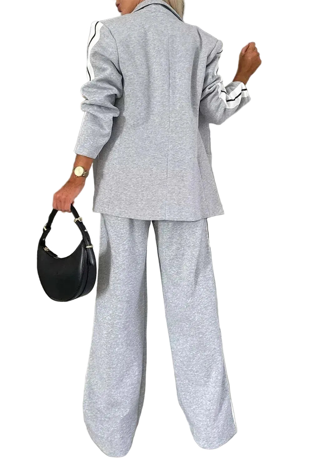 Back view of a light gray blazer and wide-leg pants with white striped sleeve and leg panels.