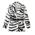 Black and white zebra-print blazer with notched lapels and two black buckle waist straps, front view.