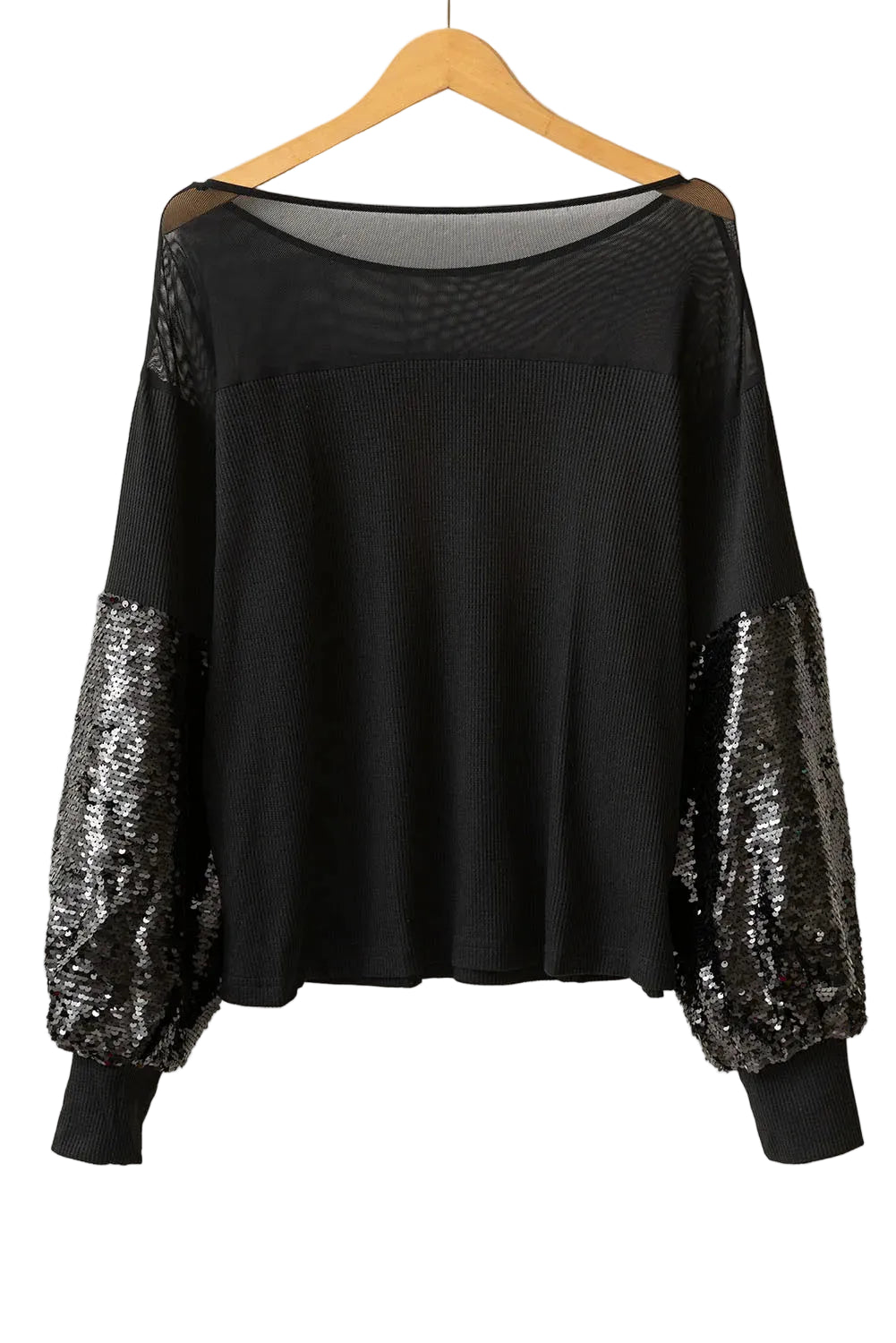 Black boat-neck blouse with sheer shoulder panels, sequined lower sleeves, and black cuffs, hanging view.