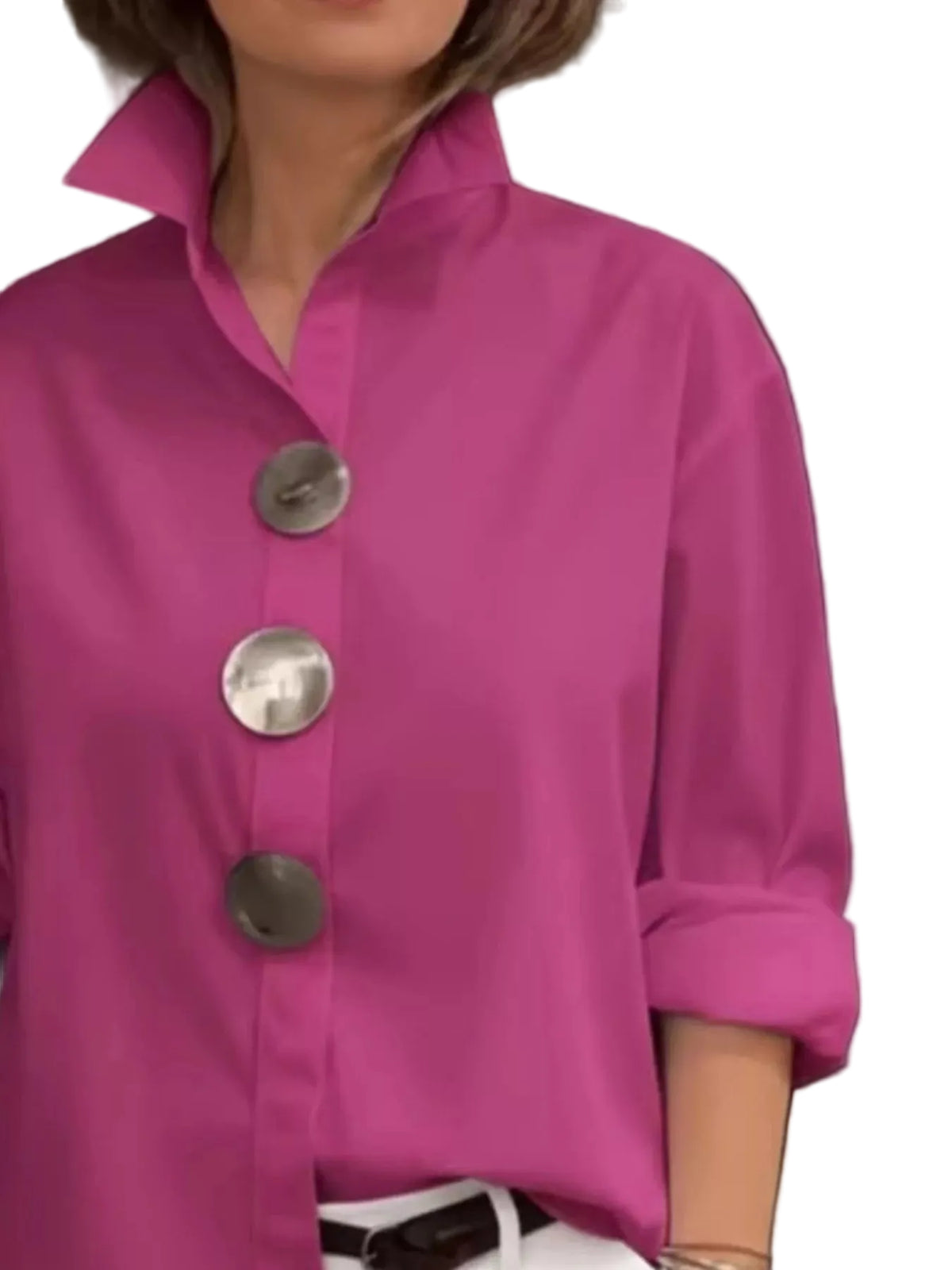 Close-up of a pink collared shirt with oversized metal buttons and rolled sleeves.