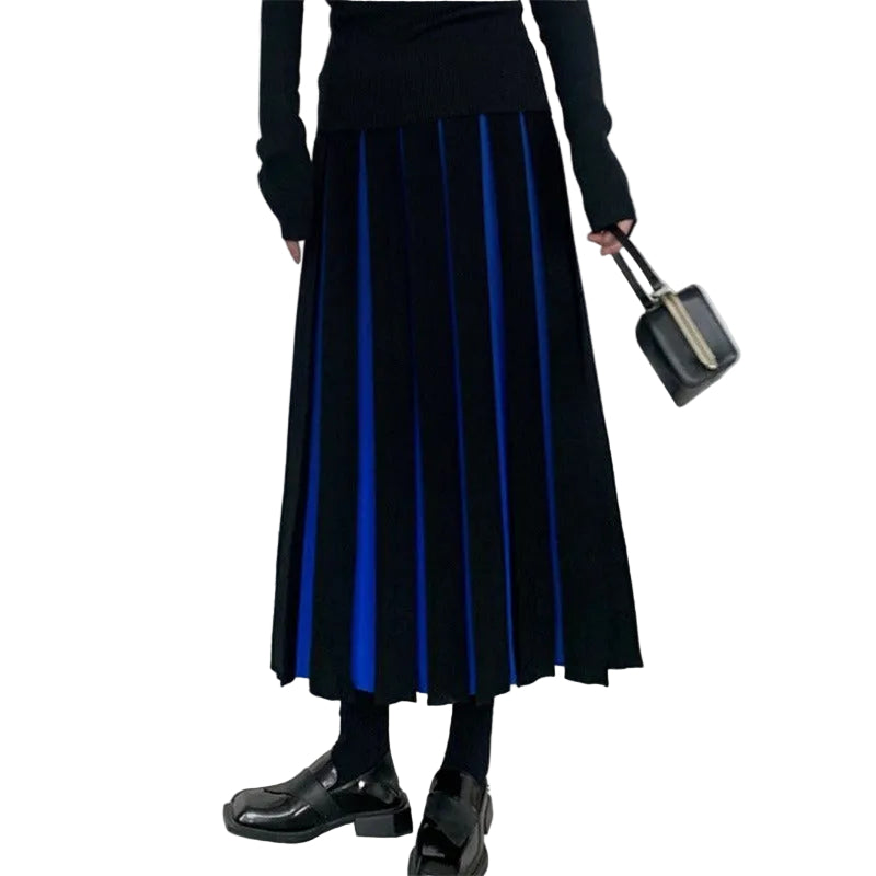 Model wearing a black pleated midi skirt with bright blue inset panels, front view.