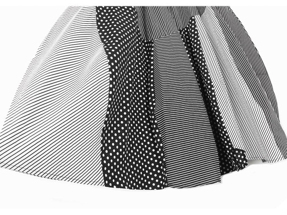 Close-up of the hem and mixed striped and polka-dot panels on a black and white skirt.