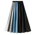 Pleated A-line skirt with gray, light blue, and black color-block panels and a black waistband.
