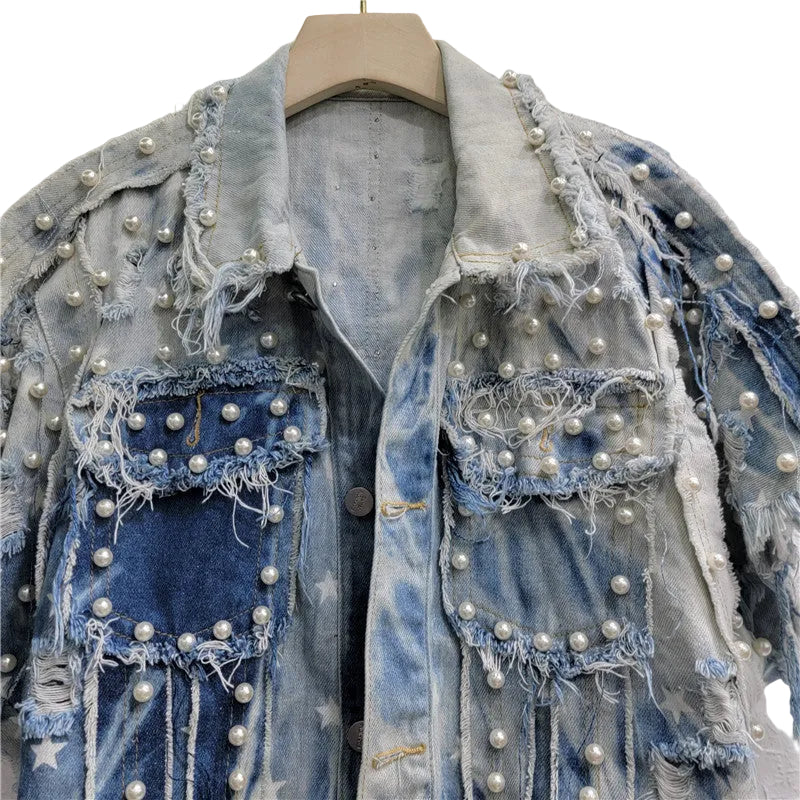 Close-up of the distressed denim top's collar, pearl-like studs, and frayed chest pockets.