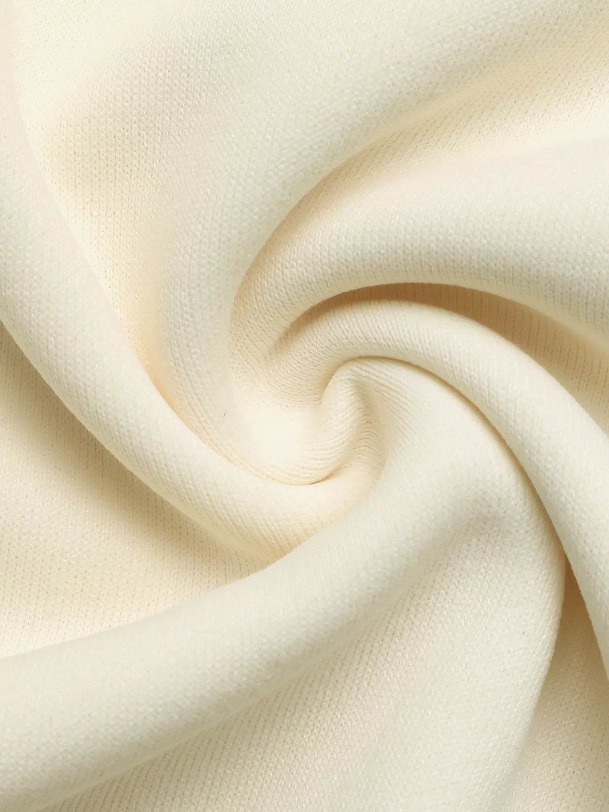 Close-up of cream sweatshirt fabric arranged in a swirl.