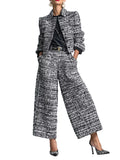 Model wearing a black and white textured cropped jacket and matching wide-leg cropped pants, front view.