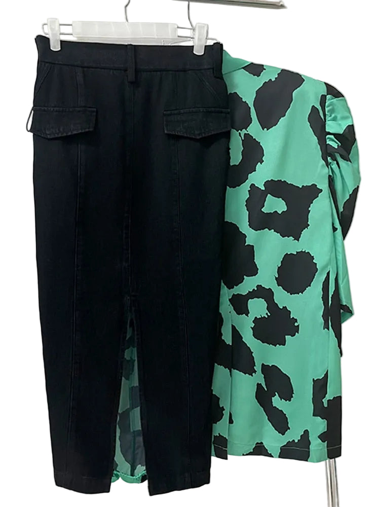 Back view of a black skirt with flap pockets, displayed beside a jade and black animal-print blazer.