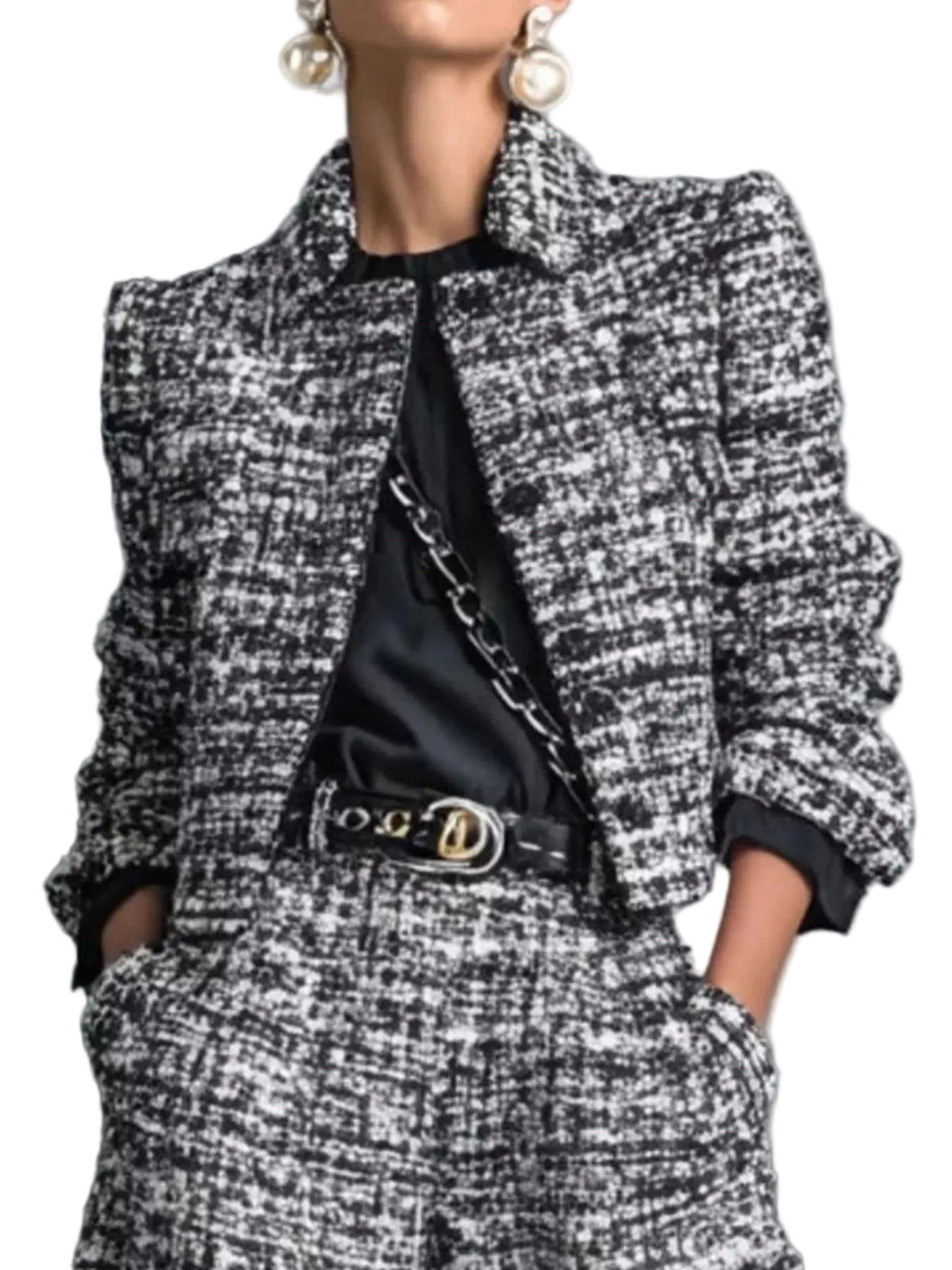 Close-up of a black and white textured cropped jacket and the matching pants' waistband and pockets.