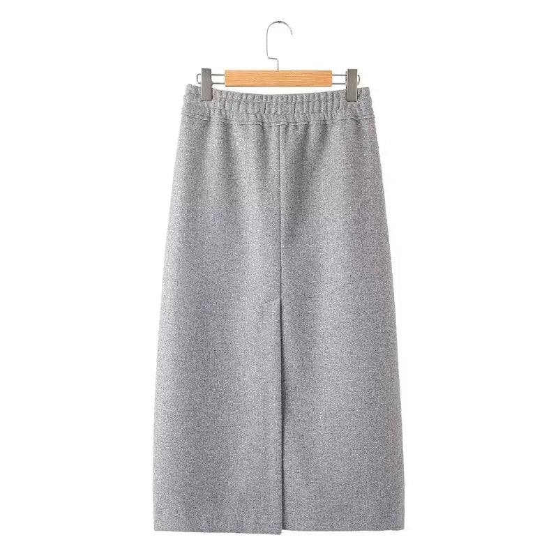 Back view of a gray midi skirt with an elastic waist, center seam, and back slit.