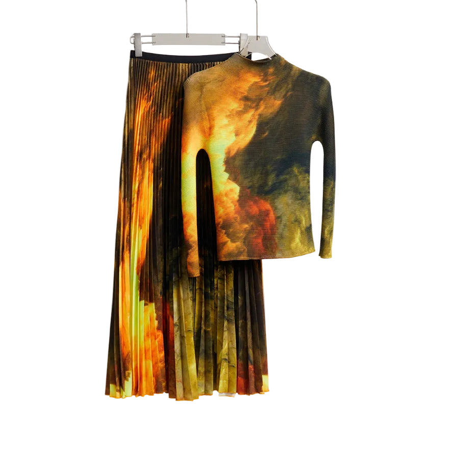 Orange, gold, and dark green abstract-print high-neck top with matching pleated midi skirt on hangers.