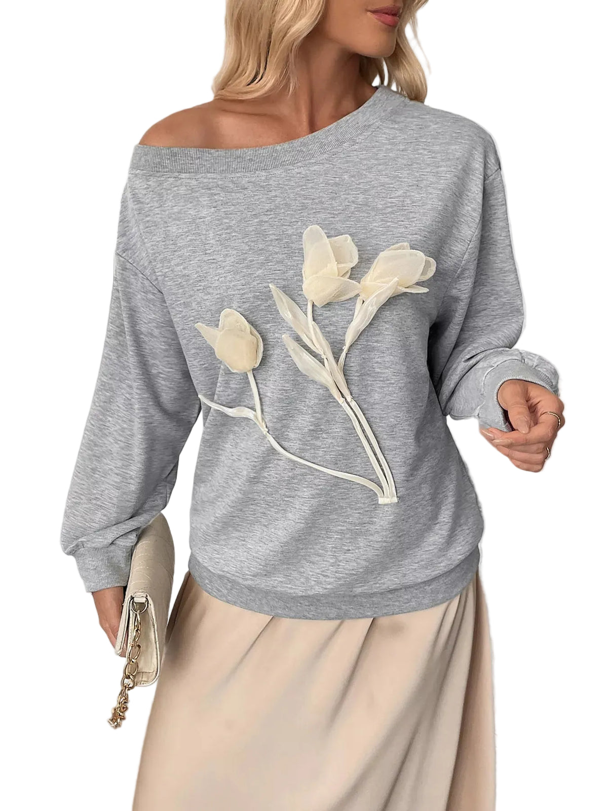 Model wearing a gray boat-neck sweatshirt with cream tulip-shaped floral appliques on the front.