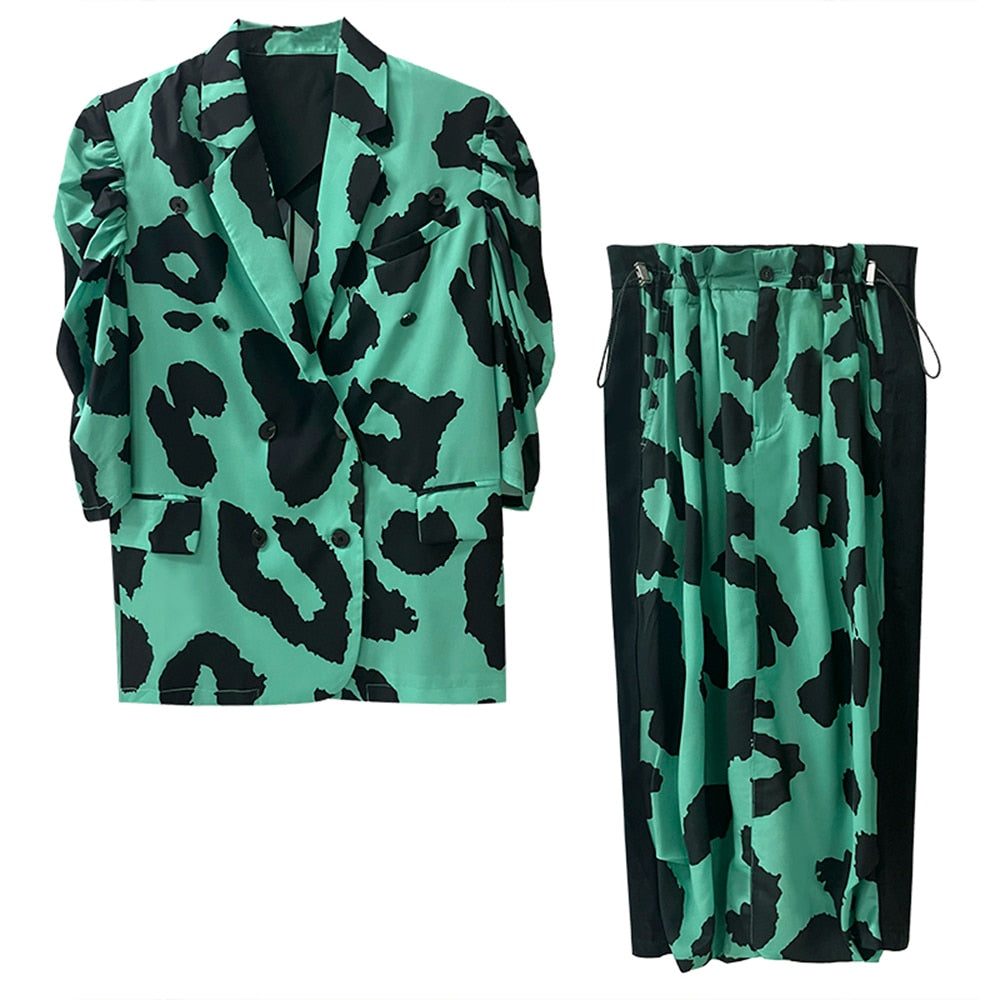 Jade green and black animal-print puff-sleeve blazer and matching skirt with black side panels, front view.