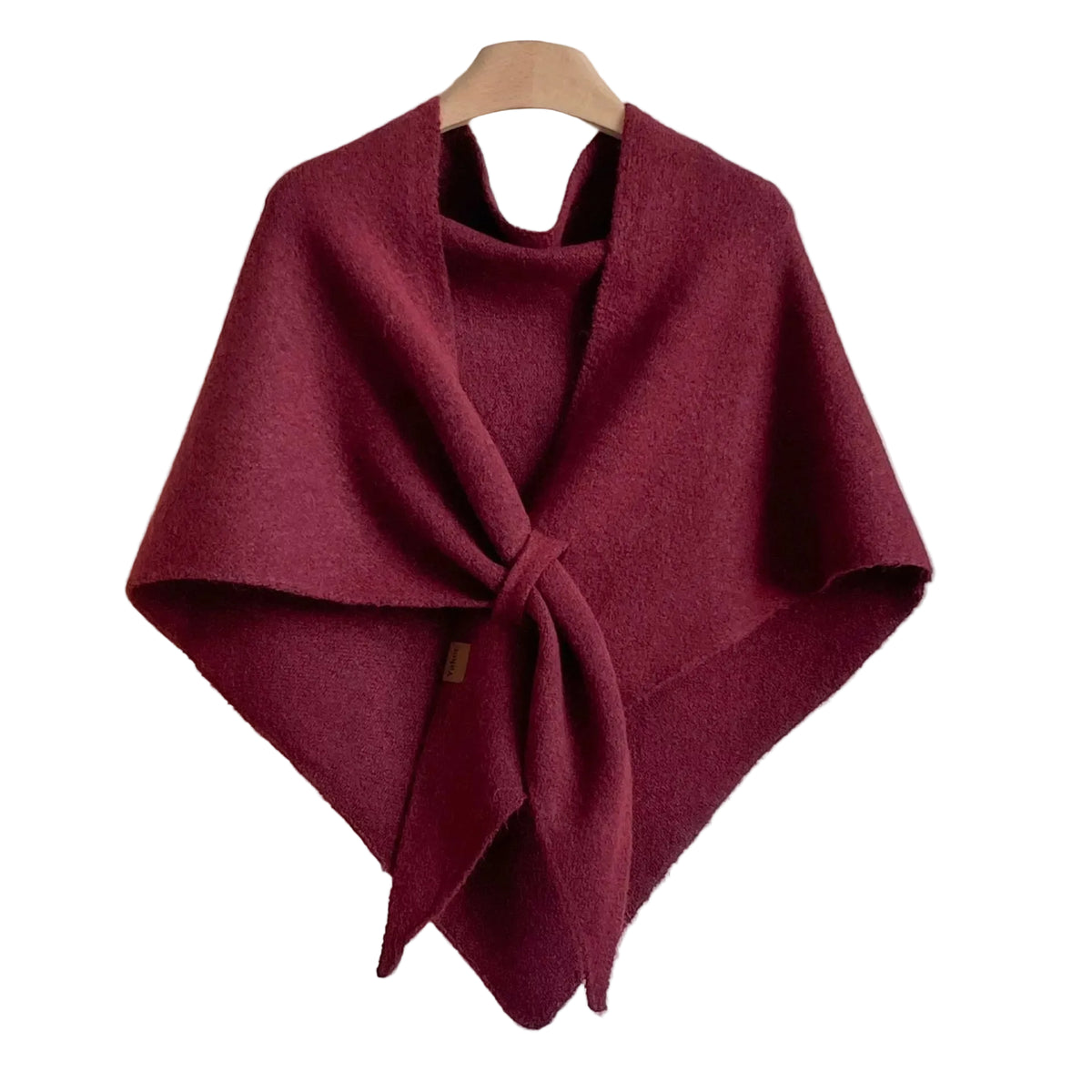 Burgundy knitted wrap shawl with long front ties crossed together, displayed on a hanger.