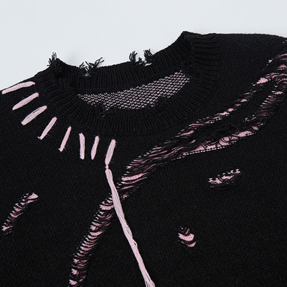 Close-up of the black distressed sweater's frayed neckline, pink stitching, and loose threads.