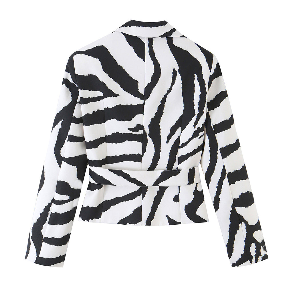 Back view of a black and white zebra-print cropped jacket with a matching waist belt.