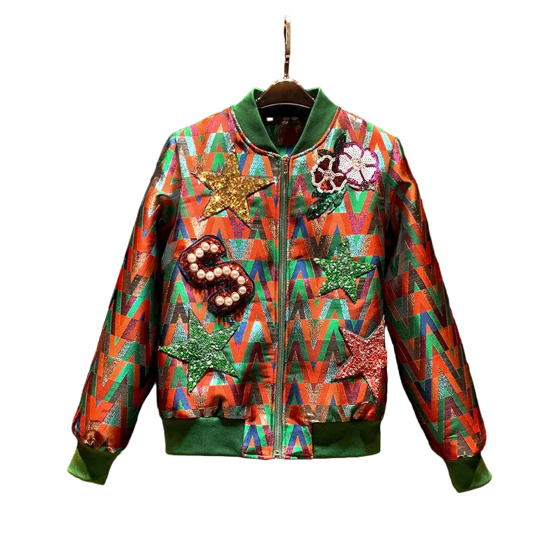 Multicolor geometric bomber jacket with green ribbed trim, sequin stars, flowers, and a beaded S patch.