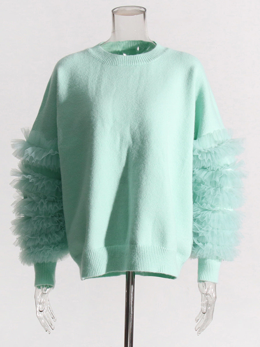 Front view of a mint green crewneck sweater with sheer sleeve ruffles on a mannequin.