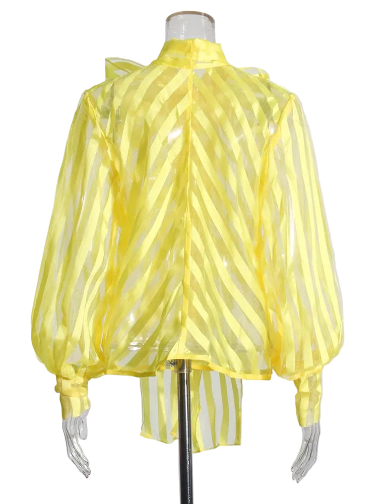 Back view of a yellow sheer striped blouse with balloon sleeves and a high neck on a mannequin.