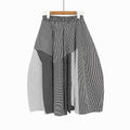 Black and white striped and polka-dot patchwork skirt with a gathered elastic waist, hanging front view.