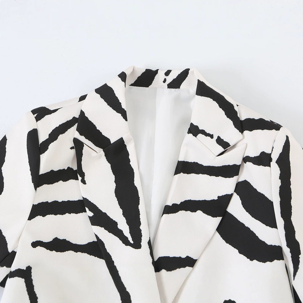 Close-up of the zebra-print blazer's notched lapels and black and white pattern.