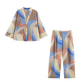 Pastel abstract-print V-neck button-front shirt and matching wide-leg pants, front view.
