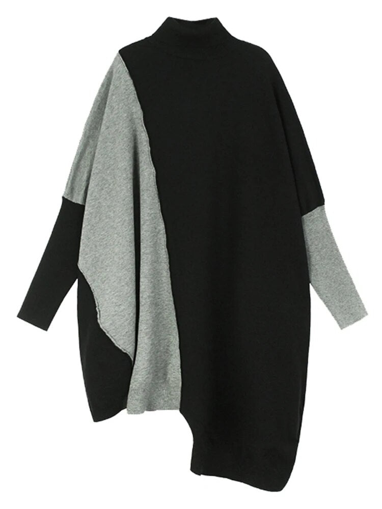 Black and gray color-block sweater with a high neck, long sleeves, and an asymmetric hem.